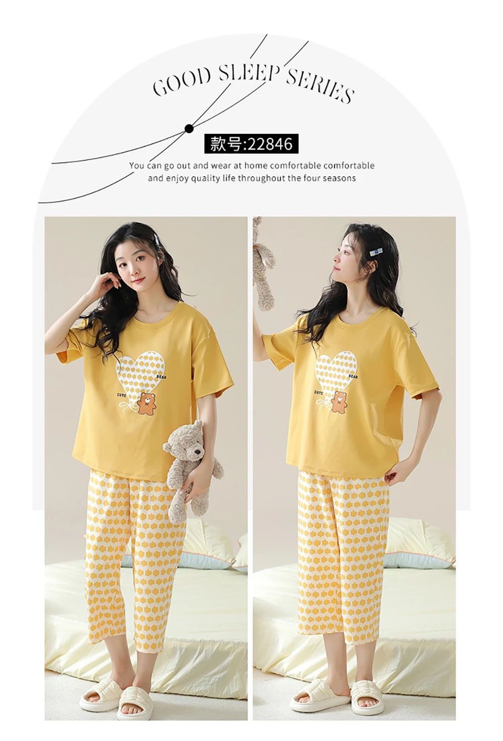 Woman wearing a yellow pajama set with a teddy bear design, sitting on a bed.