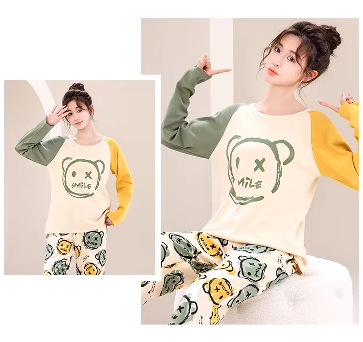 Woman wearing a matching pajama set with a cartoon design on a neutral background