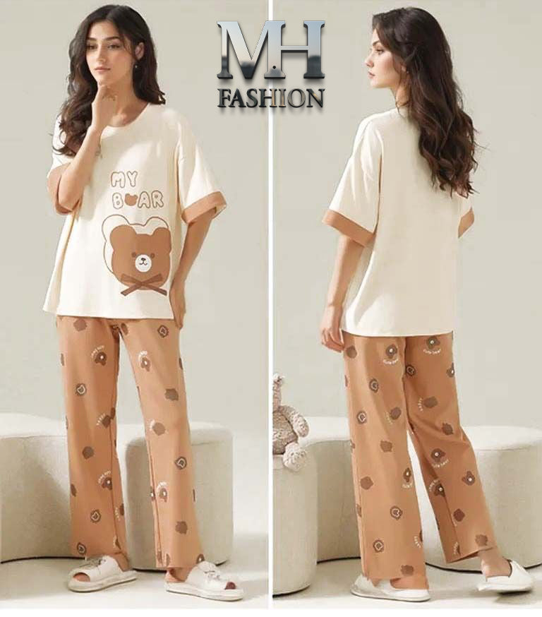 Woman wearing a pajama set with a bear design, standing in front of an MH Fashion logo.