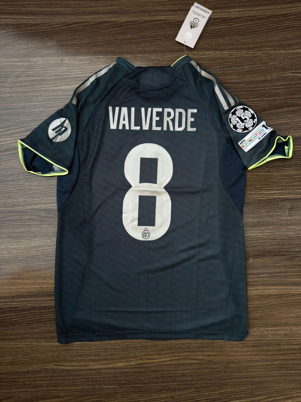 Dark green sports jersey with 'Valverde' and number '8' on a wooden surface