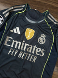 Real Madrid sports jersey with Emirates logo on a wooden surface