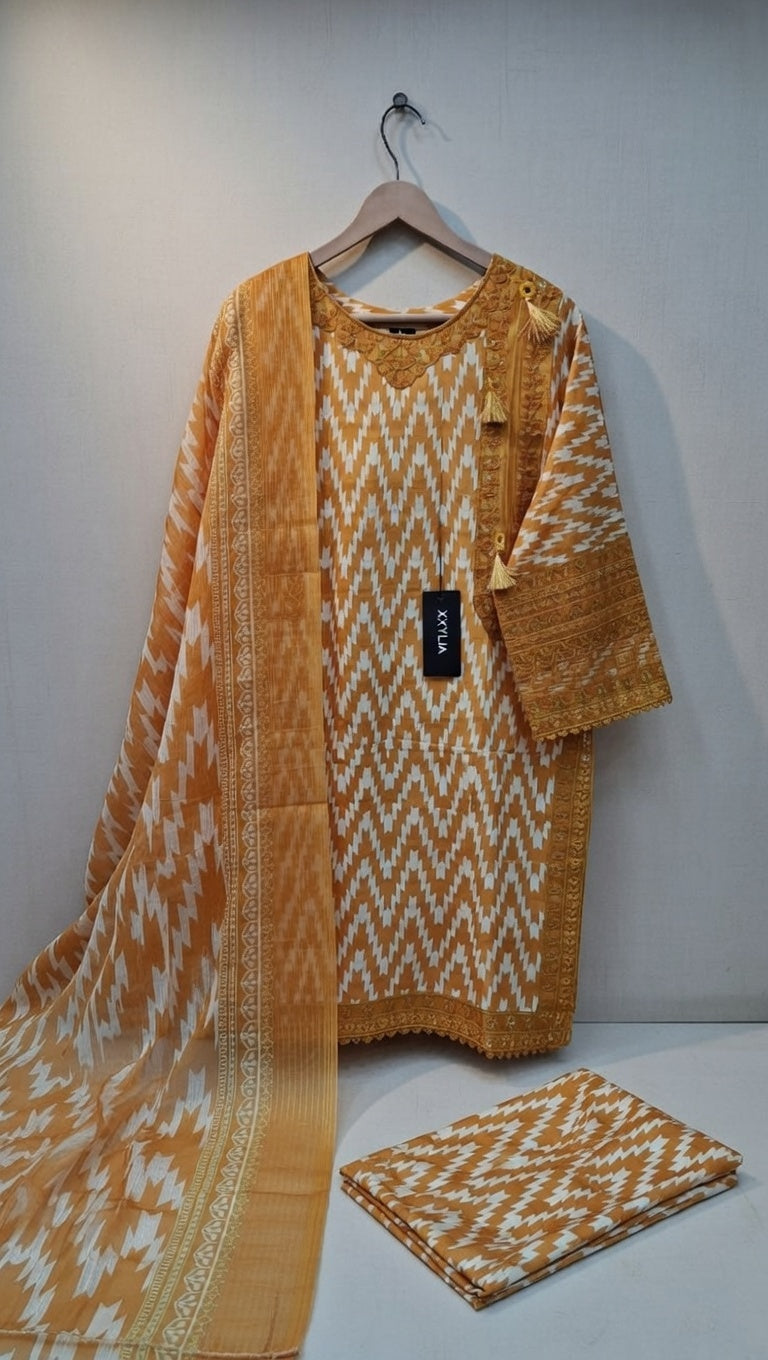 Yellow and white patterned fabric on a hanger against a white background