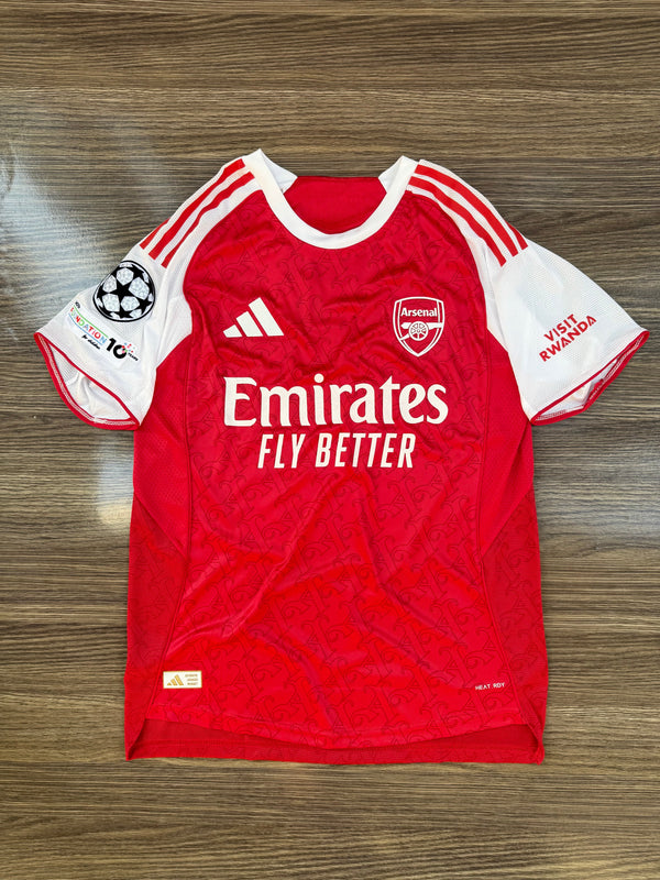 Red sports jersey with white accents on a wooden surface