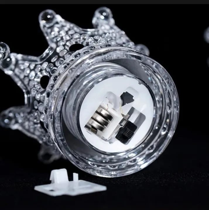 Close-up of a car headlight bulb with decorative casing on a black background
