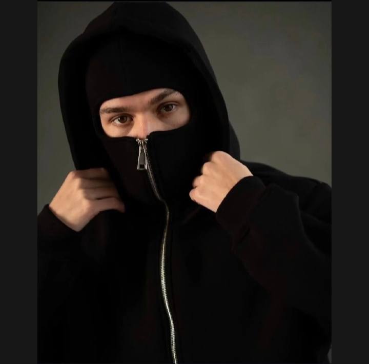 Person wearing a black hoodie with a zipper, obscuring their face.