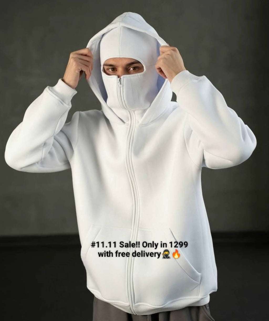 Person wearing a white hoodie with a dark background