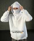 Person wearing a white hoodie with a dark background