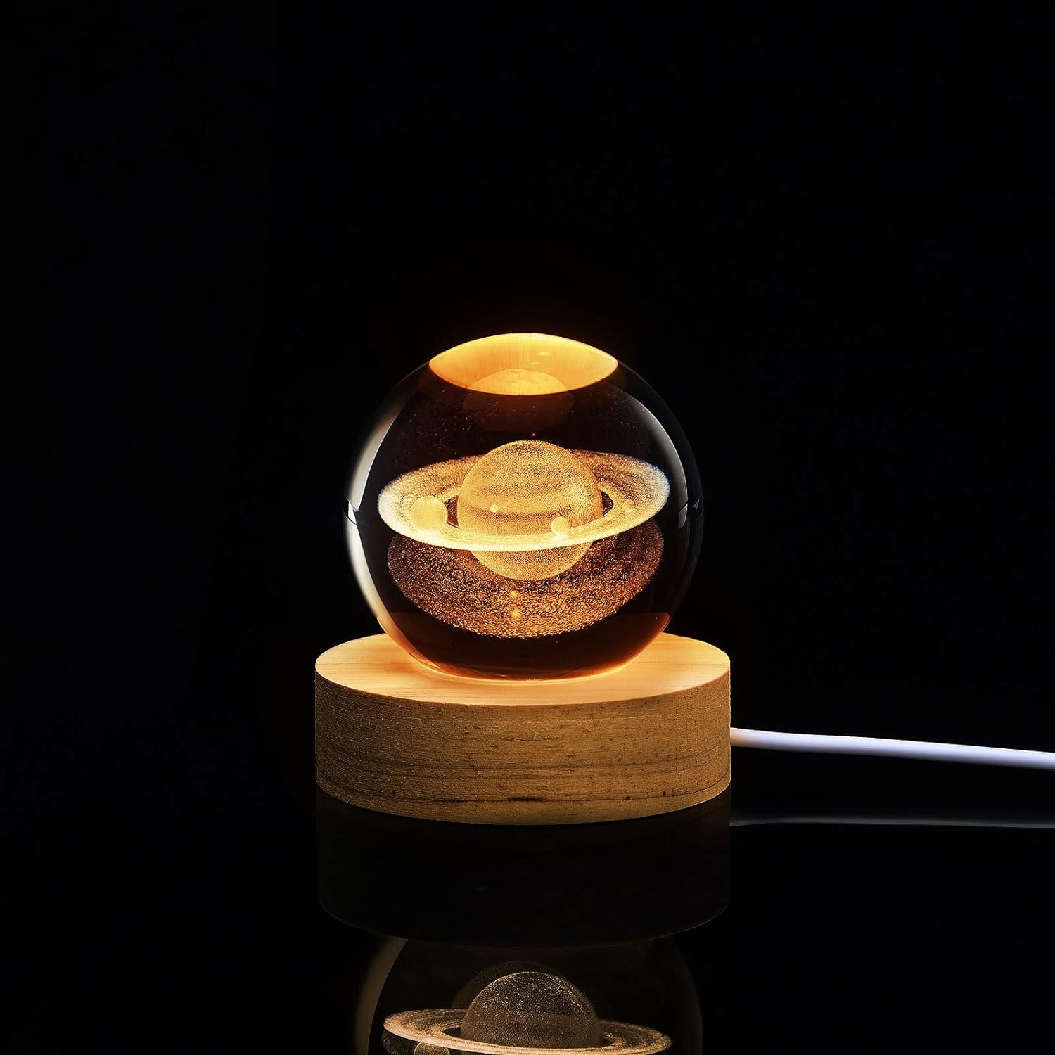 Glass orb with a wooden base on a black background