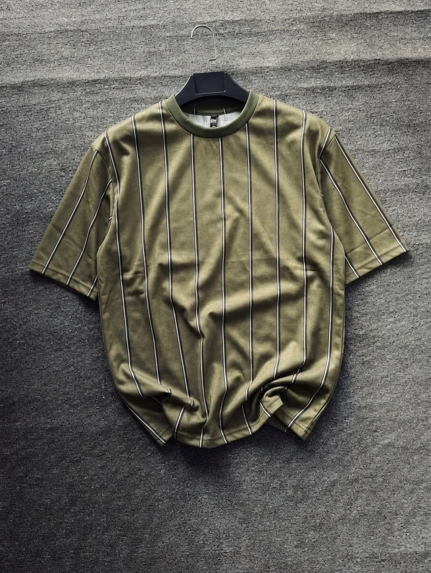 Green t-shirt with pinstripes on a gray textured background