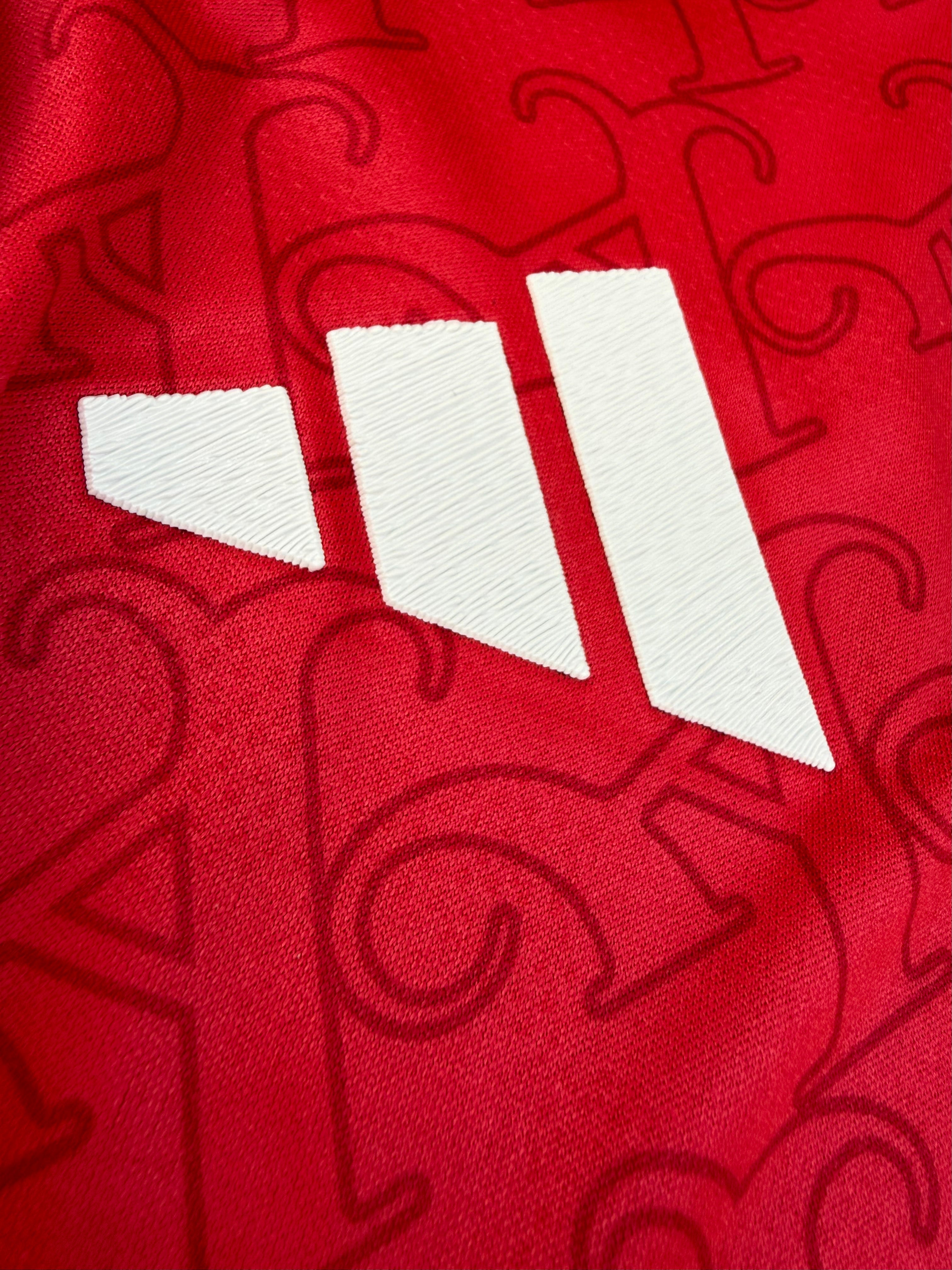 Close-up of a red sports jersey with white number 11 and brand logo.