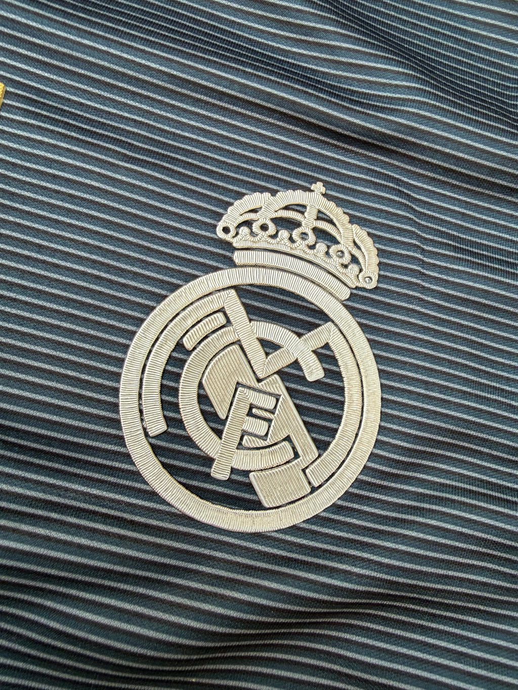Embroidered logo on a textured fabric background