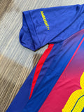 Colorful athletic shirt with 'Ambiguity' text on a wooden surface