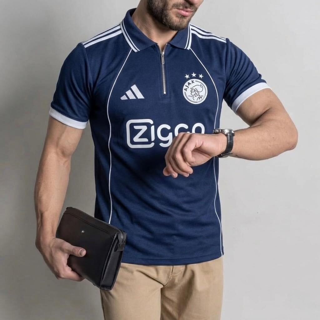 Man wearing a blue sports jersey with visible branding, holding a wallet and looking at his watch.