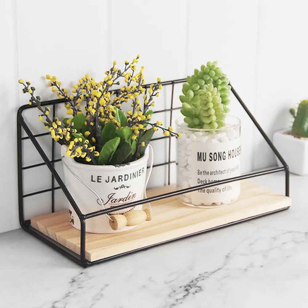 Wire shelf with plants on a marble surface