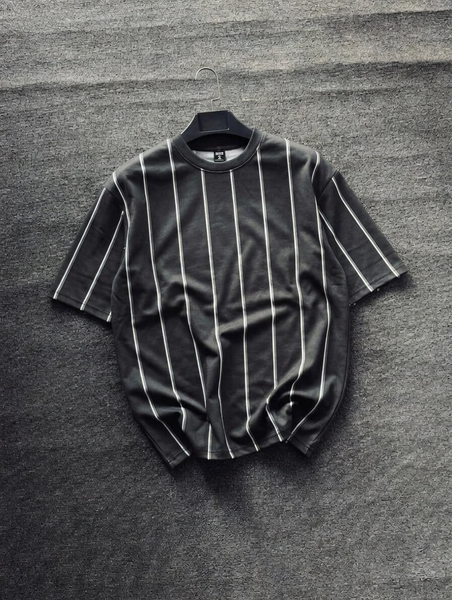 Black pinstripe shirt on a hanger against a gray textured background