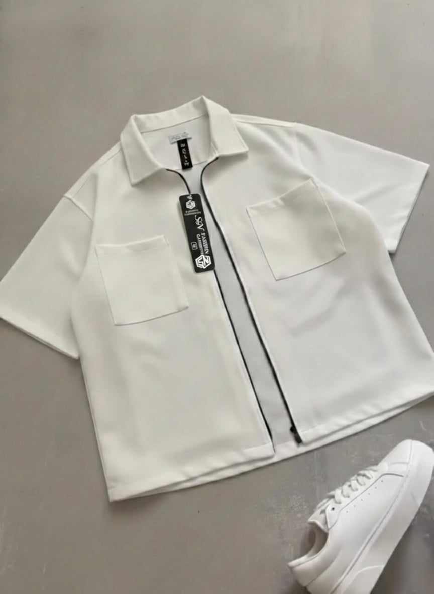 White shirt with a tag on a gray surface