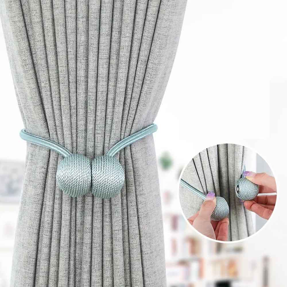 Curtain tieback with decorative ball design on a gray curtain, with close-up inset showing product details.