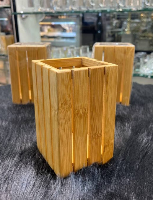 Three wooden planters on a gray surface with a blurred background