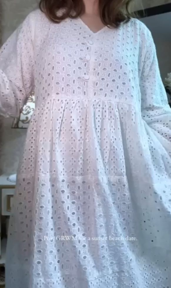 White lace dress worn by a person indoors.