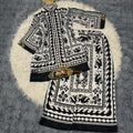 Black and white patterned fabric on a textured surface