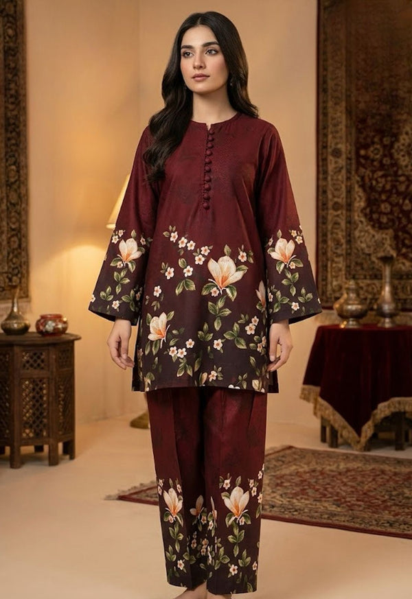 Woman wearing a maroon floral outfit in an indoor setting with decorative elements.
