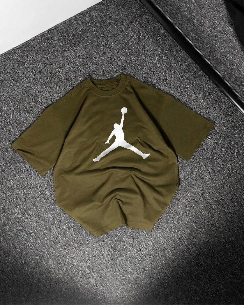 Green t-shirt with a white logo on a gray surface