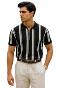 Man wearing a black and white striped shirt with a belt and light-colored pants on a white background