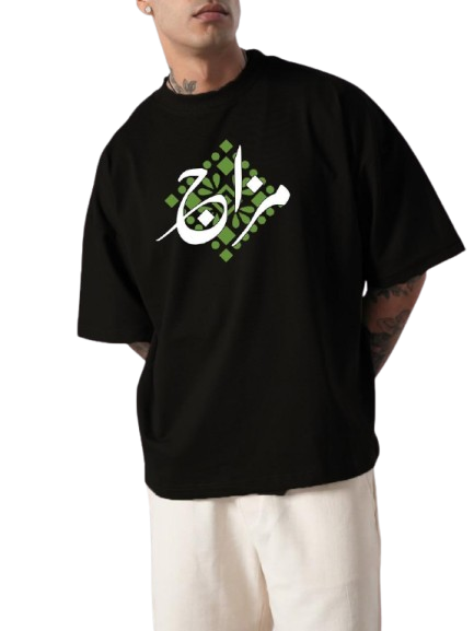 Person wearing a black t-shirt with green and white design on a white background