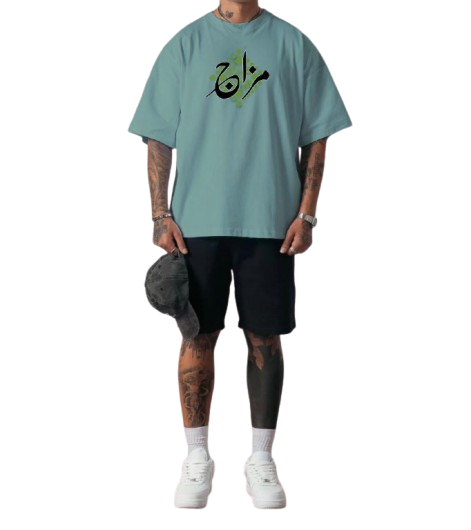 Person wearing a light blue t-shirt with Arabic text, black shorts, and white sneakers on a white background