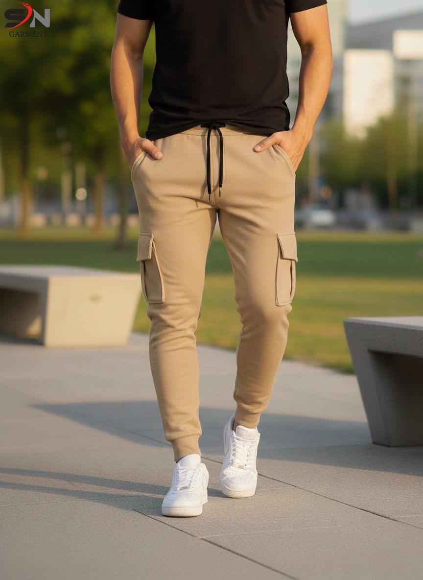 Person wearing beige cargo jogger pants and white sneakers in an outdoor setting