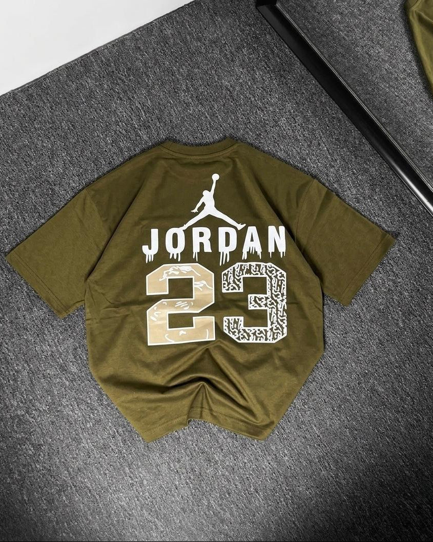 Green t-shirt with 'Jordan 23' print on a gray surface