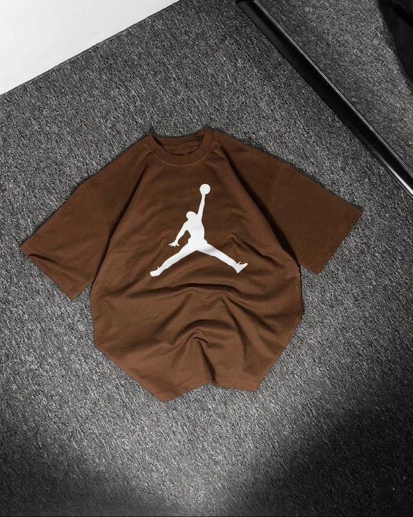 Brown t-shirt with a white logo on a gray surface