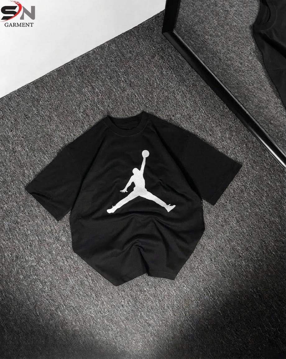 Black t-shirt with a white logo on a textured surface