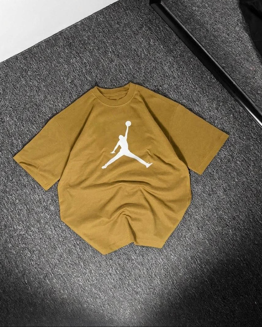 Yellow t-shirt with a white logo on a dark textured surface