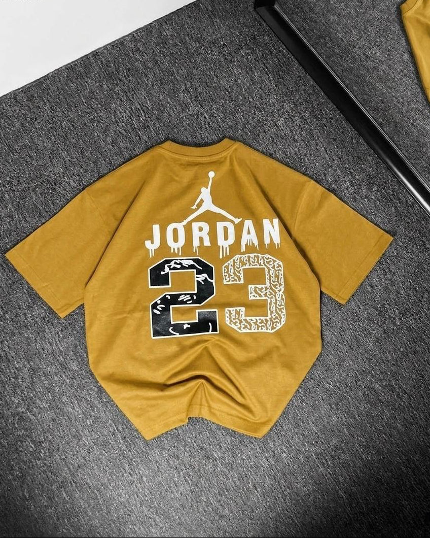 Yellow t-shirt with Jordan logo and number 23 on a gray surface
