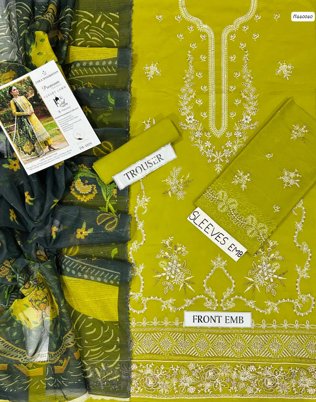Green fabric with embroidery and a label on a white background