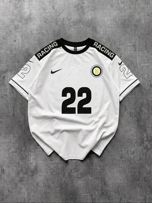 White t-shirt with black text and number 22 on a gray concrete background