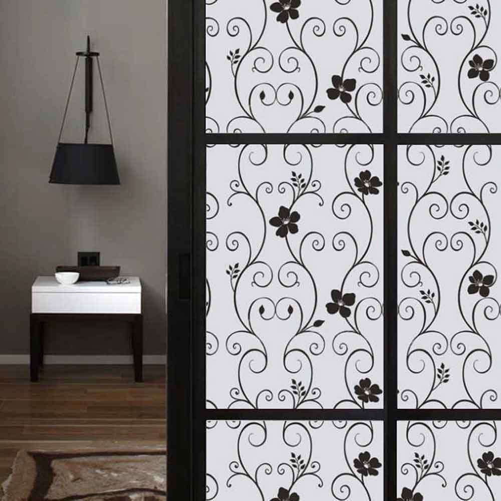 Decorative glass panel with floral and swirl patterns in a modern interior setting.