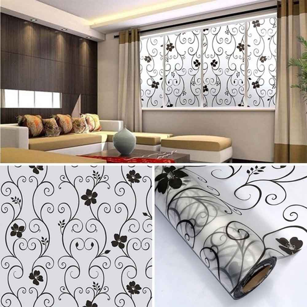 Decorative window film with floral pattern applied to a window in a living room.