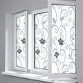 Decorative window film with floral patterns on a white window frame.