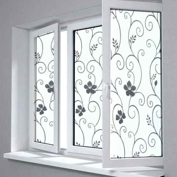 Decorative window film with floral patterns on a white window frame.