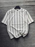 White t-shirt with black stripes on a gray textured surface