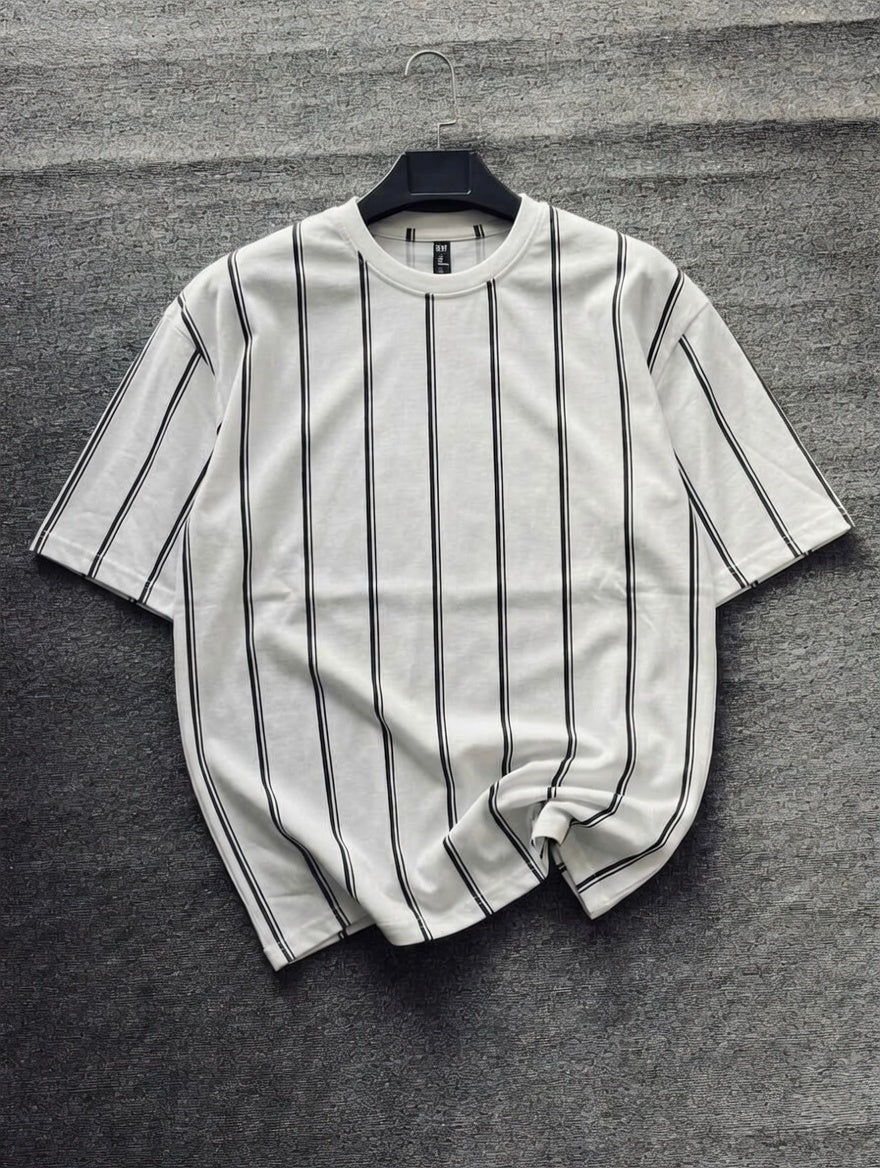 White t-shirt with black stripes on a gray textured surface