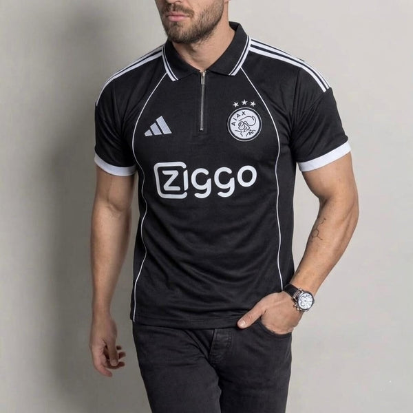 Man wearing a black sports jersey with Adidas and Ziggo logos on a gray background