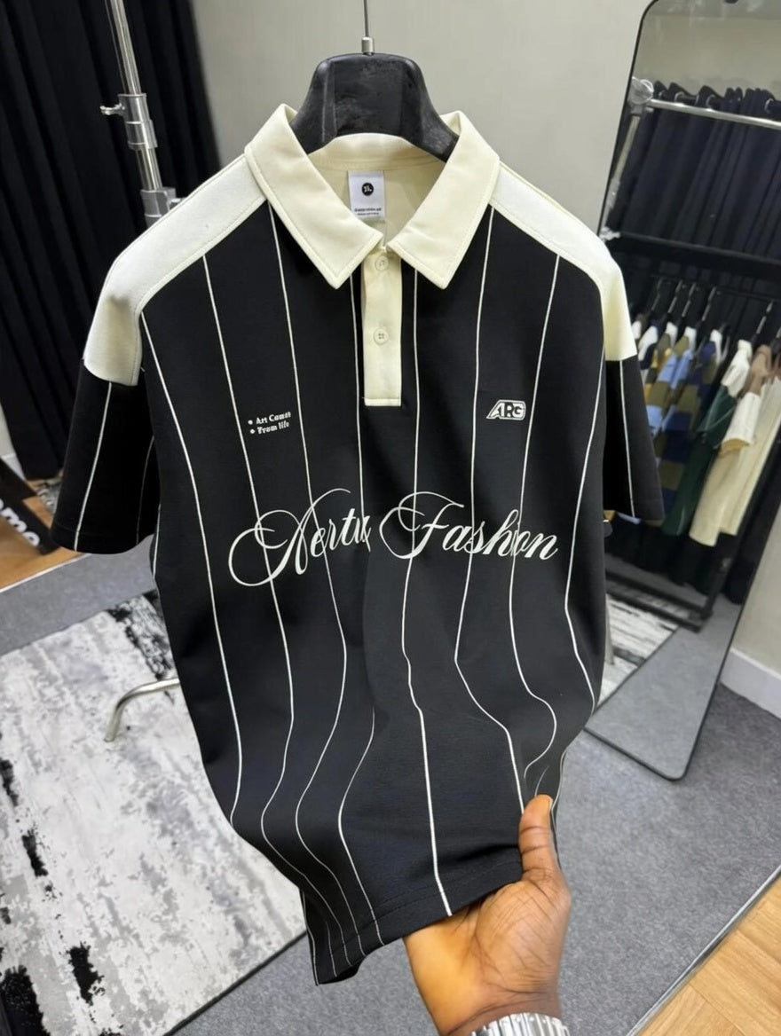 Black and white striped polo shirt with 'North Fashion' branding held by a hand.