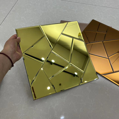 Gold geometric mirror held by a hand on a light gray surface