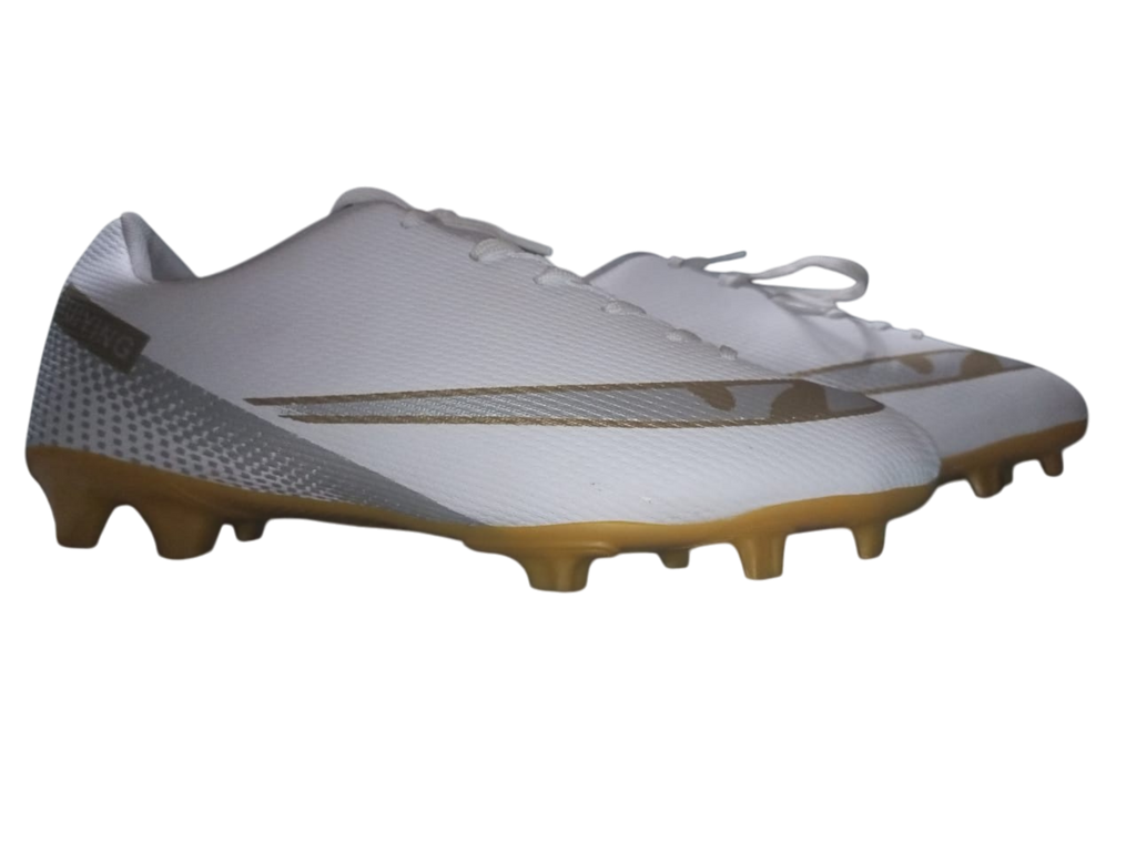 White soccer cleats with brown soles on a white background