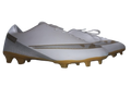 White soccer cleats with brown soles on a white background