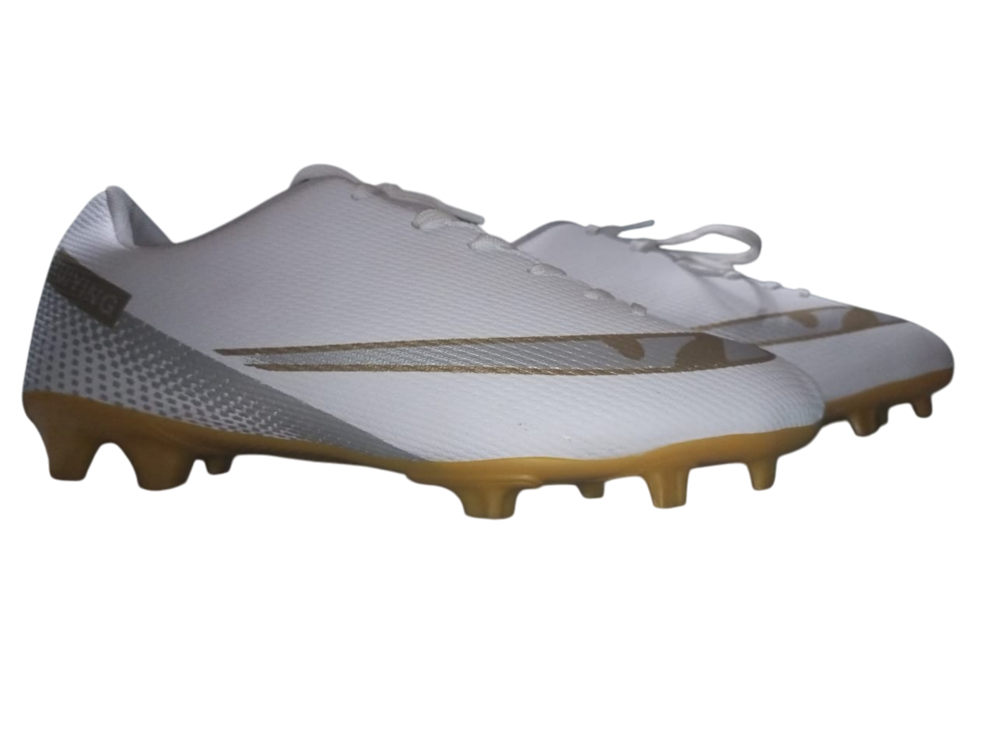White soccer cleats with brown soles on a white background