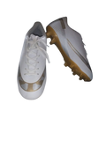 White soccer cleats with brown soles on a white background